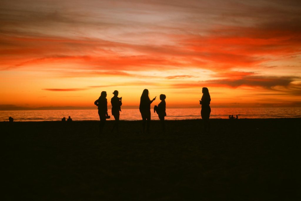 A group of people hanging out at Newport Beach, CA