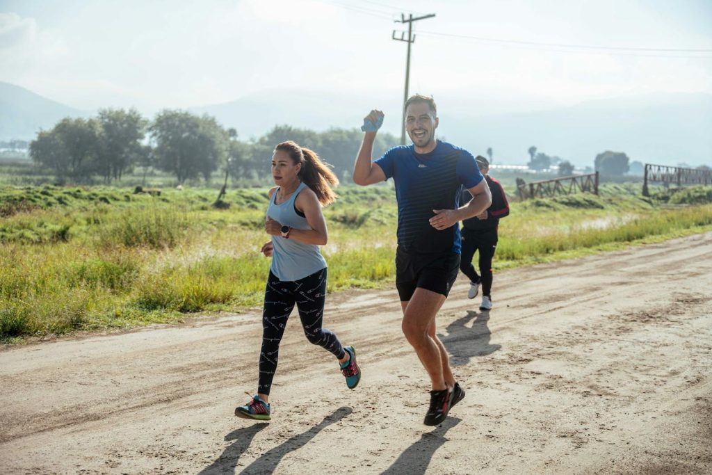 A guy running with friends after getting his back acne healed in Orange County with Accutane